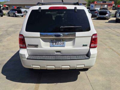 Rear Profile: Rear view showing the liftgate with flip-up glass and integrated rear parking sensors.