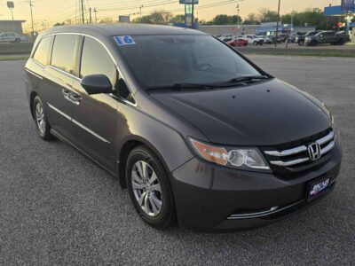 Side profile showcasing the dual power sliding doors and 17-inch alloy wheels.