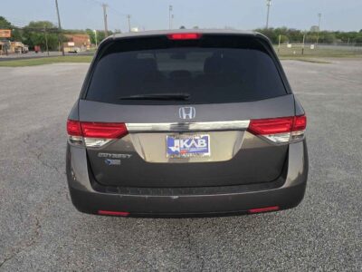 Rear perspective emphasizing the power tailgate and integrated rear spoiler.
