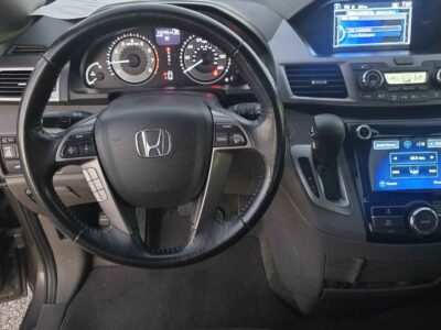 Interior cockpit view featuring the leather-trimmed heated front seats and i-MID display.