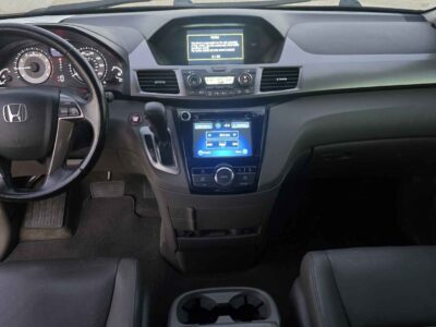 Interior cockpit view featuring the leather-trimmed heated front seats and i-MID display.