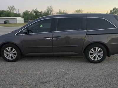 Side profile showcasing the dual power sliding doors and 17-inch alloy wheels.