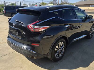 Rear perspective emphasizing the dual exhaust finishers and LED taillight architecture.
