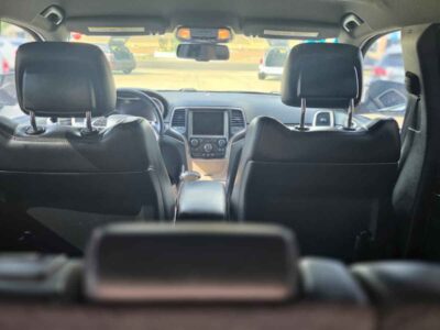 Interior Cabin: Premium Limited trim interior with Black/Light Frost Beige accents, heated leather seating, and Uconnect interface.