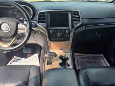 Interior Cabin: Premium Limited trim interior with Black/Light Frost Beige accents, heated leather seating, and Uconnect interface.