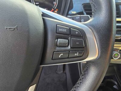 2018 BMW X1 dashboard console display showcasing leather multi-function steering wheel and central audio control interfaces