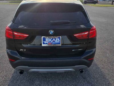 Rear fascia view layout of 2018 BMW X1 showing automated power tailgate trunk panel and high-definition reverse parking assist display lenses